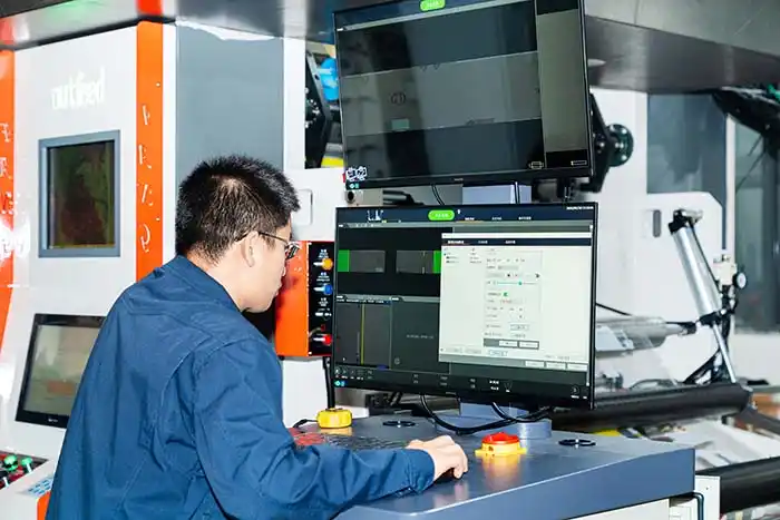 Technicians are inspecting the machine in preparation for replacing the gravure printing roller